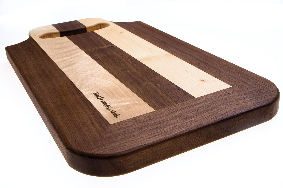 Walnut and Sycamore cutting board with handle.