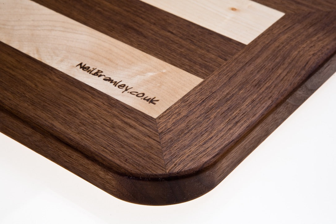 Walnut and Sycamore cutting board with handle.